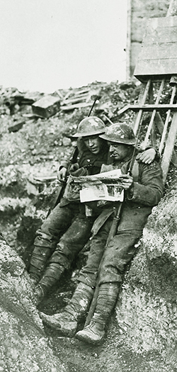 Catching up on the news: CEF soldiers on the front lines near Lens, 1918. Library & Archives Canada DAPDCAP324794